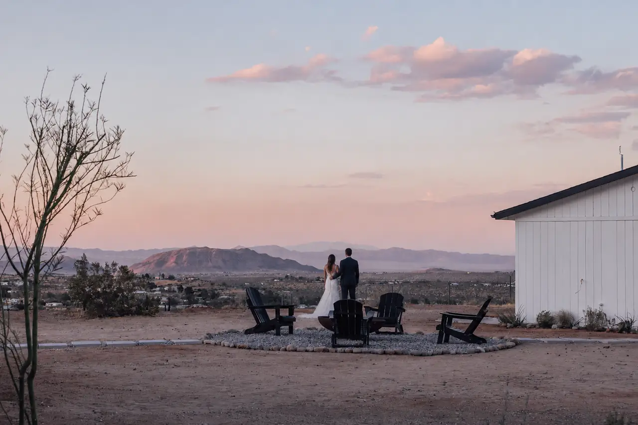 Couple gathered by the firepit at dusk